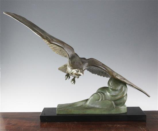 Cartier. An Art Deco bronze group of an eagle swooping over clouds, height 20.5in.